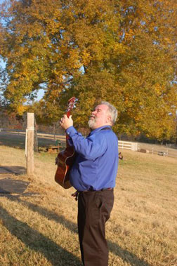 Bruce and guitar outdoors by favorite tree